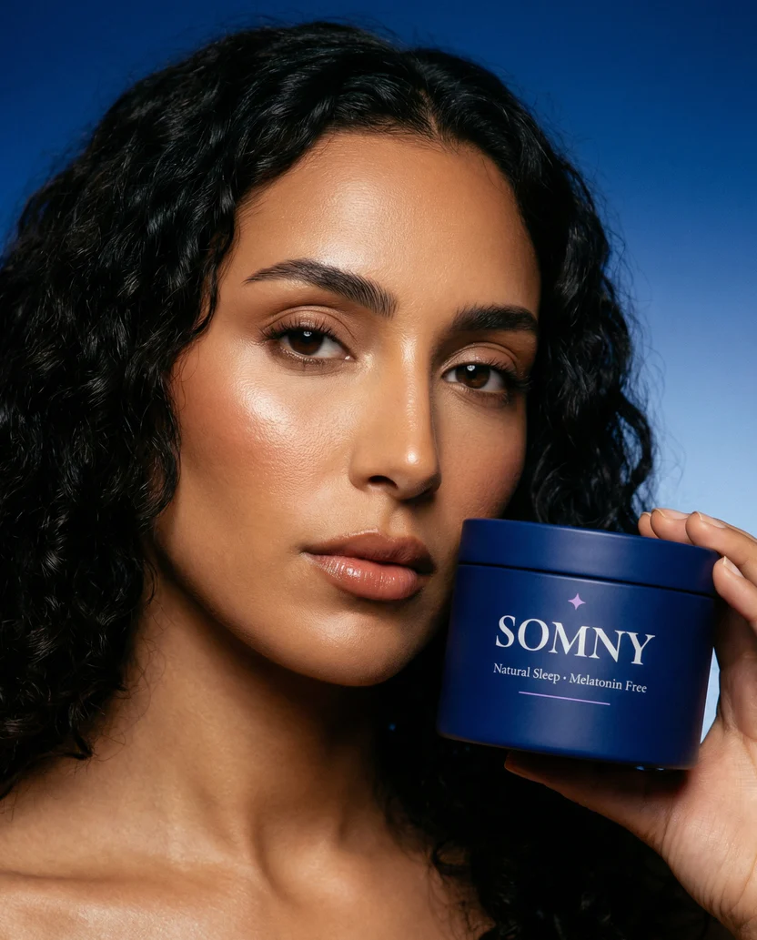 Woman holding a matte navy Somny tin next to her face